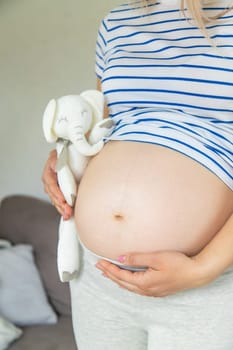 Pregnant woman and white elephant. Selective focus. Cute.
