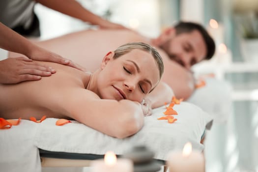 Love, relax and couple at a spa for a massage to celebrate marriage, anniversary or birthday on holiday. Man and woman sleeping with luxury care and wellness therapy for body on vacation at a hotel.