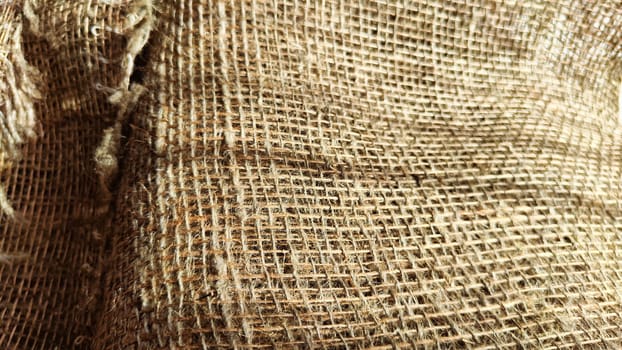 Natural fabric texture, frame and background of burlap. Rough crumpled burlap background. Selective focus
