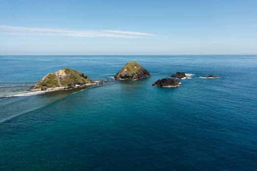 Aerial view of rocky islands and blue ocean. Seascape in the Philippines.