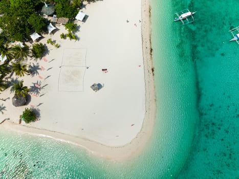 Top view of beautiful beach, palm trees by turquoise water. Bantayan island, Philippines.