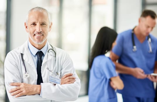 Healthcare, smile and portrait of senior doctor with arms crossed, pride and support in hospital. Health care, happiness and expert medicine, confident and happy man, medical professional in clinic