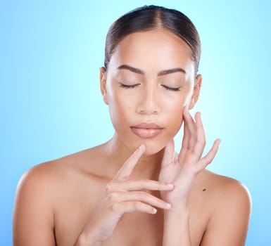 Face, beauty and skincare with a model black woman in studio on a blue background for natural treatment. Facial, eyes closed and cosmetics with an attractive young female posing to promote skin care.