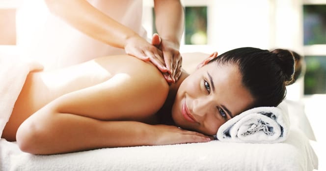 Happy woman, relax and massage at spa for healthy wellness, skincare or stress relief at resort. Calm female person relaxing with smile in peaceful zen or luxury body and back treatment at the salon.