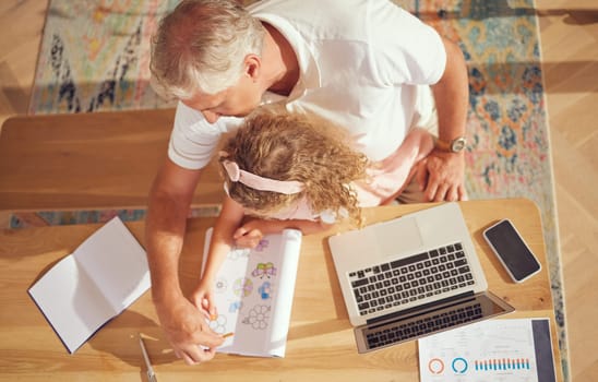 Top view, old man and girl learning drawing while her grandfather is busy with paperwork in family home office. Senior grandfather helping and teaching a creative child to color in a school project.