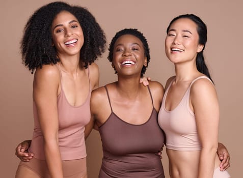 Portrait, diversity and women for body positivity, cosmetics and natural beauty on brown studio background. Multiracial, females and ladies with makeup, support and solidarity for skincare and smile
