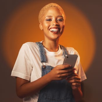 Portrait of black woman, smile and phone, typing message or email and browsing social media isolated in studio. Internet, connection and gen z fashion, happy influencer girl with smartphone in hands