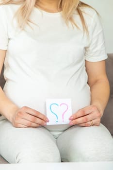 Pregnant woman who will be the question mark. Selective focus. Cute.