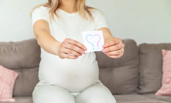 Pregnant woman who will be the question mark. Selective focus. Cute.