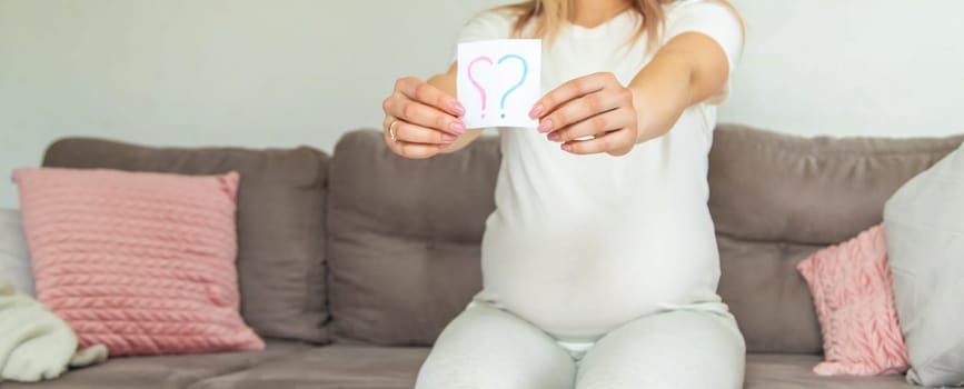 Pregnant woman who will be the question mark. Selective focus. Cute.