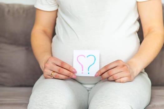 Pregnant woman who will be the question mark. Selective focus. Cute.