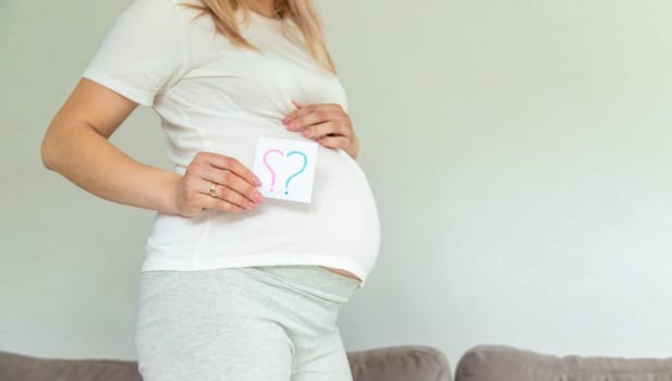 Pregnant woman who will be the question mark. Selective focus. Cute.