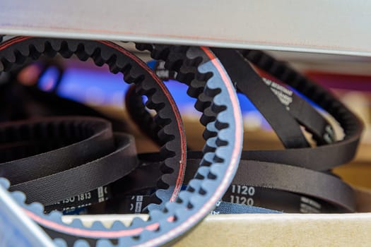 Toothed drive belt for a compressor in a box in stock. Close-up. High quality photo