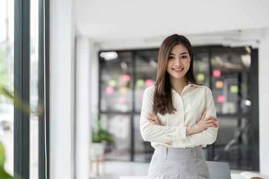 Portrait of businesswoman in office looking at camera. Confident business woman with.