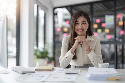 Portrait of businesswoman in office looking at camera. Confident business woman with.