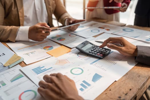 Business team analyzing income charts and graphs with calculator and tablet. Close up. Business analysis and strategy concept.