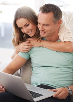 Laptop, sofa and happy couple with home internet for online planning, website review and check application together. Hug, love and affection of mature woman, partner or people on computer technology.