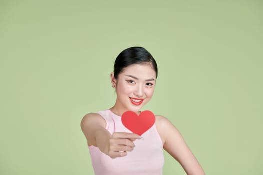 Beautiful woman in love and holding heart shape