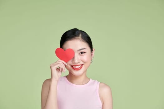 Valentine's Day. Beautiful young woman with heart in her hands.