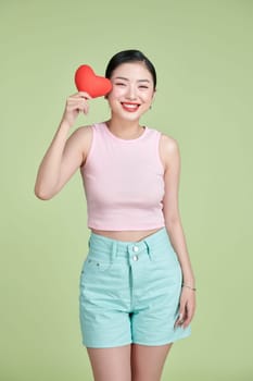 young smile woman hold red heart.