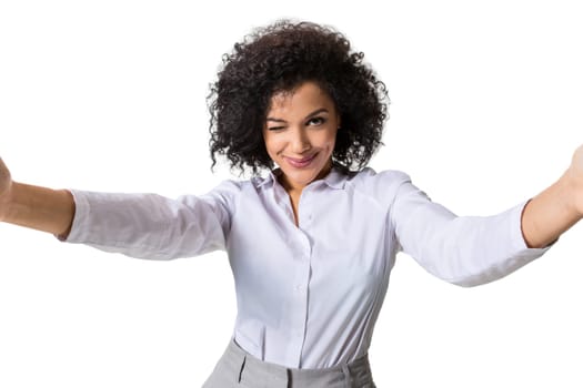 Young beautiful African American woman makes self against the white background in studio. Emotions. Isolated on white background