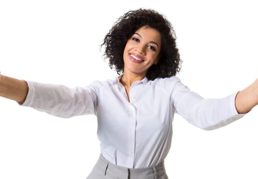 Young beautiful African American woman makes self against the white background in studio. Emotions. Isolated on white background