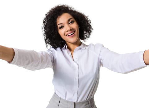 Young beautiful African American woman makes self against the white background in studio. Emotions. Isolated on white background