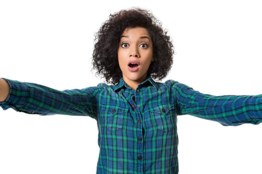 Young beautiful African American woman makes self against the white background in studio. Emotions. Isolated on white background