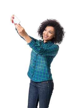Young woman in blue shirt makes selfie on a white background. isolated