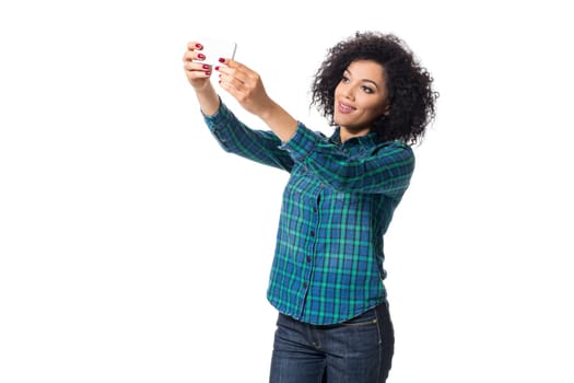 Young woman in blue shirt makes selfie on a white background. isolated