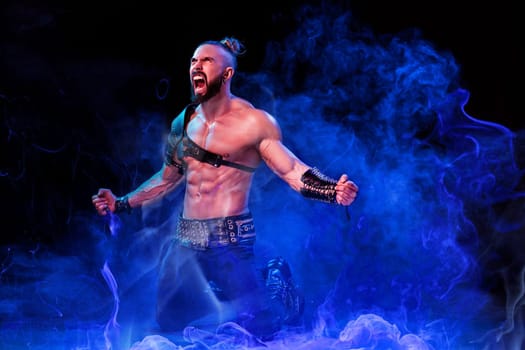 Handsome young sexy man with beautiful muscular chest in interesting costume on the scene. The Stripper man. Show time