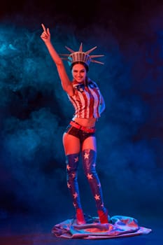 Young woman in stage costume of striptease dancer posing. Sexy woman in a statue of America costume