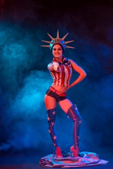 Young woman in stage costume of striptease dancer posing. Sexy woman in a statue of America costume