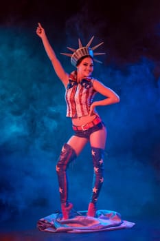 Young woman in stage costume of striptease dancer posing. Sexy woman in a statue of America costume