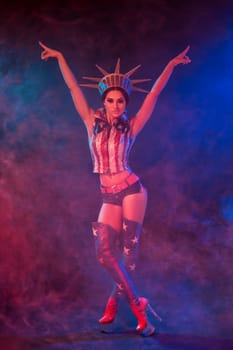 Young woman in stage costume of striptease dancer posing. Sexy woman in a statue of America costume
