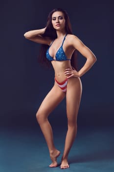 Sexy woman in swimsuit. Woman posing in studio