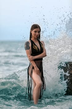 Model pose in modern swimwear by sea. Beautiful sexy lady on tropical beach. Relax portrait of young sunbathing beauty. Summer vibes on the beach