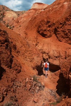 Woman in valley of Mars landscapes in the Altai Mountains, Kyzyl Chin, Siberia, Russia