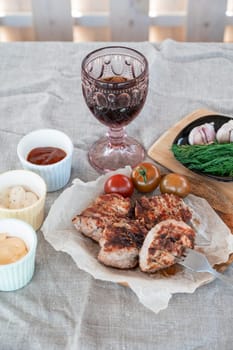 Grilled pork meat in foil with flapjack and vegetables. Summer rest concept