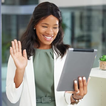 Tablet, wave and video call with a business black woman at work in her office for an online meeting. Communication, networking and internet with a female employee waving during a wireless chat.