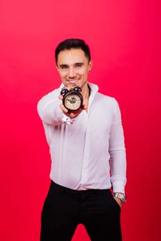 It is your time. Portrait of young man in showing time on a clock watch, ok, thumb up, approve