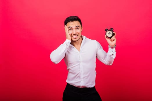 It is your time. Portrait of young man in showing time on a clock watch, ok, thumb up, approve