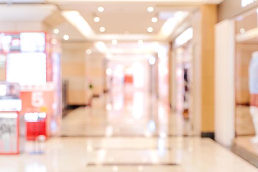 Luxury department store shopping mall interior, abstract defocused blur with bokeh background, concept of shopping seasons design.