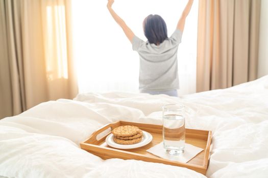 Tray with breakfast on a bed in a hotel room