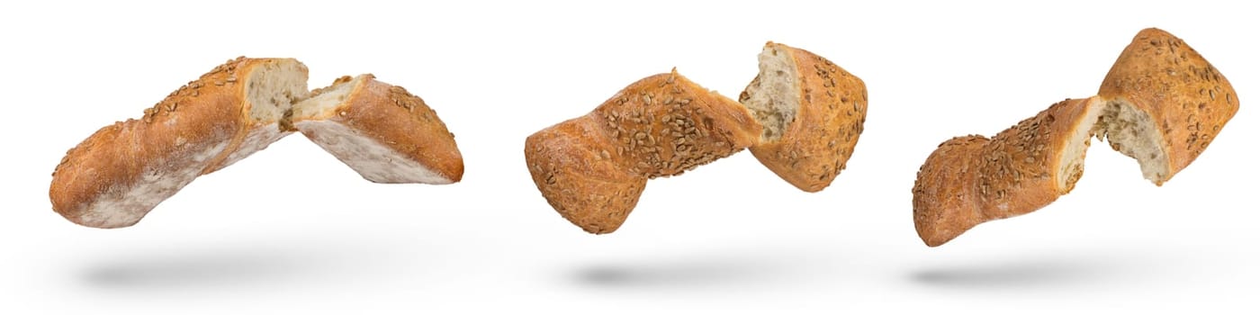 Set of isolates of broken loaves of bread. A set of loaves of light bread on a white isolated background. Healthy food concept. A loaf broken in half falls, casting a shadow. Side view.