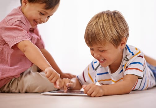 Children, playing and tablet for learning and education in family home for happiness and fun. Male kids or friends together for play, laughing and streaming on internet for development with app video.