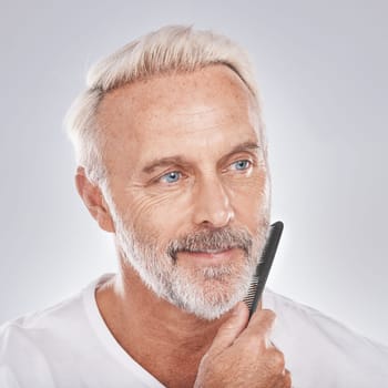 Beard comb, mature man and face on studio background for growth maintenance, barber cleaning and healthy skincare. Male model, facial and brushing hair care for beauty, aesthetic fashion or cosmetics.