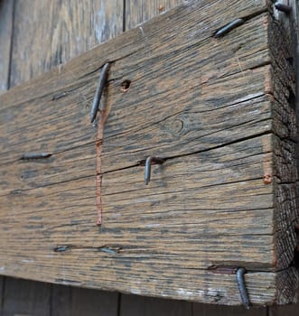 An old wooden board with some nails sticking out