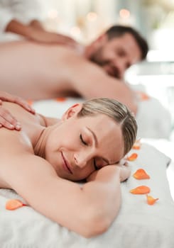 Wellness, beauty and couple massage at spa for health and relax in zen resort, peaceful and happy. Salon, luxury and man and woman enjoy treatment by massage therapist on their vacation in Thailand.