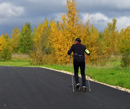 Moscow, Russia - 29 Sept. 2021. man on roller skis rides along a sports track in Zelenograd